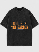 Oversized black graphic tee with 'God Is In The Garden' print