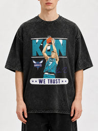Model wearing a vintage black basketball graphic tee with a bold design