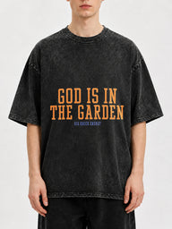 Oversized black graphic tee with 'God Is In The Garden' print