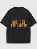 Oversized black graphic tee with 'God Is In The Garden' print