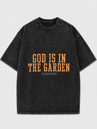 Oversized black graphic tee with 'God Is In The Garden' print